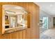 Modern kitchen with stone countertops and white cabinetry, as seen through a wood pass through at 304 Bank St, Mount Pleasant, SC 29464