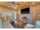 Inviting outdoor porch with brick fireplace, comfortable seating, and ceiling fan at 304 Bank St, Mount Pleasant, SC 29464