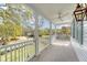 Wide front porch with white railings and columns, featuring a ceiling fan at 304 Bank St, Mount Pleasant, SC 29464