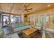 Relaxing screened porch with a ceiling fan, comfortable seating, and outdoor view at 304 Bank St, Mount Pleasant, SC 29464