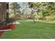 Grassy backyard with a patio and mulch bed along the side of the brick house at 305 Mayfield St, Summerville, SC 29485