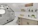 Modern bathroom features a glass-enclosed shower with a black trim and updated vanity and mirror at 305 Mayfield St, Summerville, SC 29485