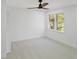 Cozy bedroom featuring a large window, neutral carpet, and a ceiling fan at 305 Mayfield St, Summerville, SC 29485