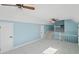 Bonus room with blue walls, white carpet and trim, ceiling fans and stairs to another level at 305 Mayfield St, Summerville, SC 29485