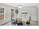 Well-lit dining room features an elegant chandelier and a view to the outside at 305 Mayfield St, Summerville, SC 29485