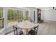 Light-filled dining area showcases large windows and a rustic table with seating at 305 Mayfield St, Summerville, SC 29485