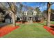 Charming brick home boasts a well-manicured front yard, mature trees, and a cozy, inviting appeal at 305 Mayfield St, Summerville, SC 29485