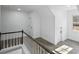 Upstairs hallway with wood-look floors, white walls, and natural light from a window at 305 Mayfield St, Summerville, SC 29485