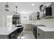 Updated kitchen with stainless steel appliances, light grey cabinets, and bright white quartz countertops at 305 Mayfield St, Summerville, SC 29485