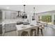 Well-lit kitchen features gray cabinets, an island with seating, and new appliances at 305 Mayfield St, Summerville, SC 29485