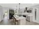 Bright kitchen with gray cabinets, stainless appliances, and breakfast bar at 305 Mayfield St, Summerville, SC 29485