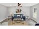 Bright living room with a ceiling fan, blue sofa, and stylish decorations shown from a high angle at 305 Mayfield St, Summerville, SC 29485
