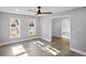Living room featuring a ceiling fan, windows for light, and wood flooring at 305 Mayfield St, Summerville, SC 29485