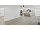 Open-concept living room with modern grey wood floors and a view of the updated kitchen at 305 Mayfield St, Summerville, SC 29485
