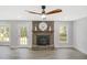 Bright living room features a brick fireplace, ceiling fan, and neutral paint at 305 Mayfield St, Summerville, SC 29485