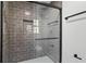 Sleek shower with glass door, black hardware, gray tile, and built-in niche at 305 Mayfield St, Summerville, SC 29485