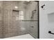 Shower stall featuring gray subway tile, a glass door, and black hardware at 305 Mayfield St, Summerville, SC 29485