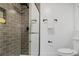 Bathroom shower featuring gray tile, glass door, and matte black shower head at 305 Mayfield St, Summerville, SC 29485