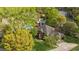 Aerial view showcasing a brick home, sparkling pool, mature trees, and a serene lake at 3176 Hagerty Dr, Charleston, SC 29414