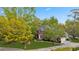 Aerial view of a brick home with lush green lawn, mature trees and a long driveway at 3176 Hagerty Dr, Charleston, SC 29414
