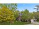 Aerial view of a brick home with lush green lawn, mature trees and a long driveway at 3176 Hagerty Dr, Charleston, SC 29414