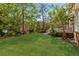 Expansive backyard with lush green lawn, leading to serene lake views and mature landscaping at 3176 Hagerty Dr, Charleston, SC 29414