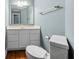 Powder room with white vanity, large mirror, and a toilet on hardwood flooring at 3176 Hagerty Dr, Charleston, SC 29414
