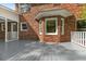 Exterior view of the home's deck, showcasing its access to natural light and charming brick exterior at 3176 Hagerty Dr, Charleston, SC 29414
