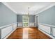 Elegant dining room with hardwood floors, wainscoting, chandelier, and natural light at 3176 Hagerty Dr, Charleston, SC 29414