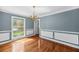 Elegant dining room with hardwood floors, wainscoting, chandelier, and natural light at 3176 Hagerty Dr, Charleston, SC 29414