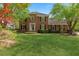 Charming two-story brick home featuring a well-manicured lawn and beautiful landscaping at 3176 Hagerty Dr, Charleston, SC 29414