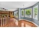 Living room with hardwood floors, a brick fireplace, and built-in shelving, next to a sunny dining area at 3176 Hagerty Dr, Charleston, SC 29414