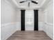 Bedroom boasts a tray ceiling, ceiling fan, large window, and stylish wainscoting at 334 Dahlia Row Dr, Summerville, SC 29486