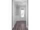 Bright entryway featuring wood-look floors and white wainscoting, creating a welcoming and stylish entrance at 334 Dahlia Row Dr, Summerville, SC 29486