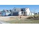 Inviting exterior view of a home with gray trim, showcasing its well-maintained lawn and simple landscaping at 334 Dahlia Row Dr, Summerville, SC 29486
