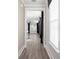 Hallway view showcasing sleek wood-look floors and large windows, creating a bright and airy feel at 334 Dahlia Row Dr, Summerville, SC 29486