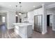 Spacious kitchen showcasing a large island, stainless steel appliances, and white cabinetry with gray accents at 334 Dahlia Row Dr, Summerville, SC 29486