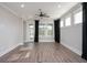Bright living room with large windows, modern ceiling fan, and hard surface floors at 334 Dahlia Row Dr, Summerville, SC 29486