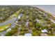 Aerial view of a scenic coastal neighborhood with lush trees and waterfront properties, near a golf course at 3510 Myrtle St, Edisto Island, SC 29438