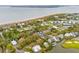 Aerial view of a coastal neighborhood with houses nestled among lush trees near the beach and a lake at 3510 Myrtle St, Edisto Island, SC 29438