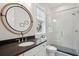 Modern bathroom featuring a round mirror and a glass shower with white tiled walls at 3510 Myrtle St, Edisto Island, SC 29438