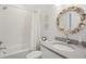 Charming bathroom with a seashell mirror, subway tile shower, and decorative artwork at 3510 Myrtle St, Edisto Island, SC 29438