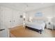 Bright bedroom features neutral tones, a ceiling fan, and natural light with wood flooring at 3510 Myrtle St, Edisto Island, SC 29438