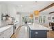 A well-lit kitchen showcases a large island, stainless steel appliances, and white cabinetry at 3510 Myrtle St, Edisto Island, SC 29438