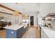 Spacious kitchen featuring an island, wooden ceiling beams, stainless steel appliances and white cabinets at 3510 Myrtle St, Edisto Island, SC 29438