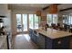 Open kitchen featuring an island with a farmhouse sink, stainless steel appliances, and a door to the outside patio at 3510 Myrtle St, Edisto Island, SC 29438