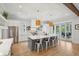 Bright kitchen featuring white cabinetry, a large island with seating, and stainless steel appliances at 3510 Myrtle St, Edisto Island, SC 29438