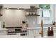 Close-up of a modern kitchen highlighting sleek countertops, stainless steel appliances, and a tiled backsplash at 3510 Myrtle St, Edisto Island, SC 29438