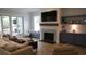 Cozy living room with a stone fireplace, custom built-ins, and comfortable seating, perfect for relaxing at 3510 Myrtle St, Edisto Island, SC 29438