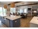 Open-concept kitchen flowing into a comfortable living area with stone fireplace and modern furnishings at 3510 Myrtle St, Edisto Island, SC 29438